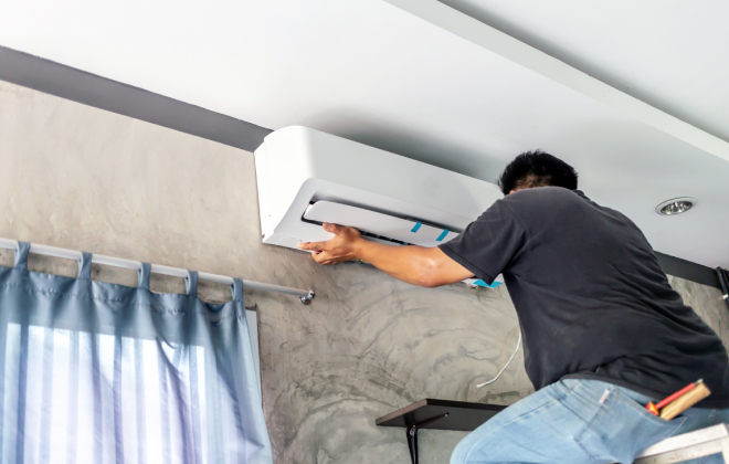 Worker Installing Air Conditioner