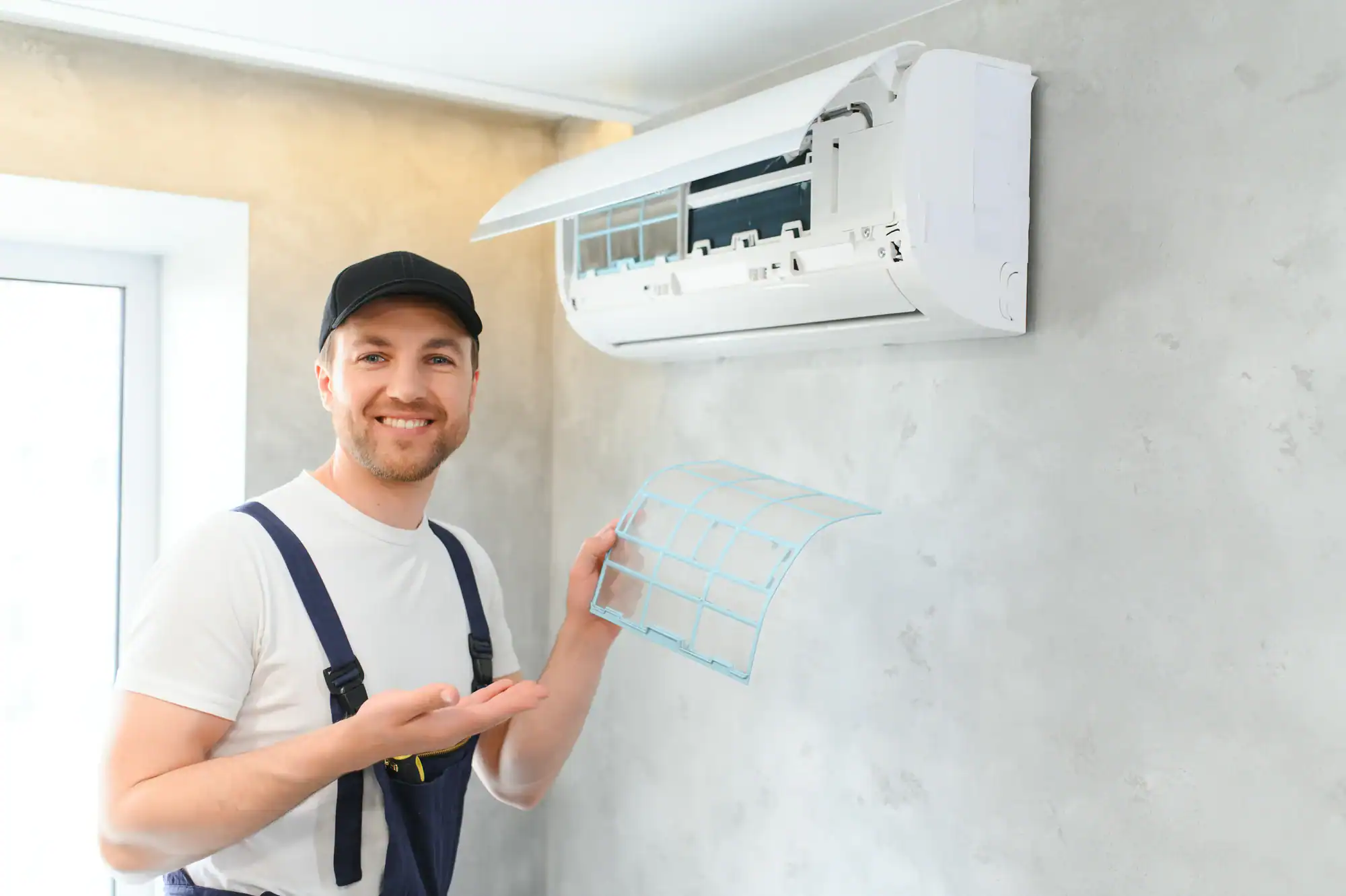 Man cleaning an AC filter during HVAC maintenance in Essex County, New Jersey