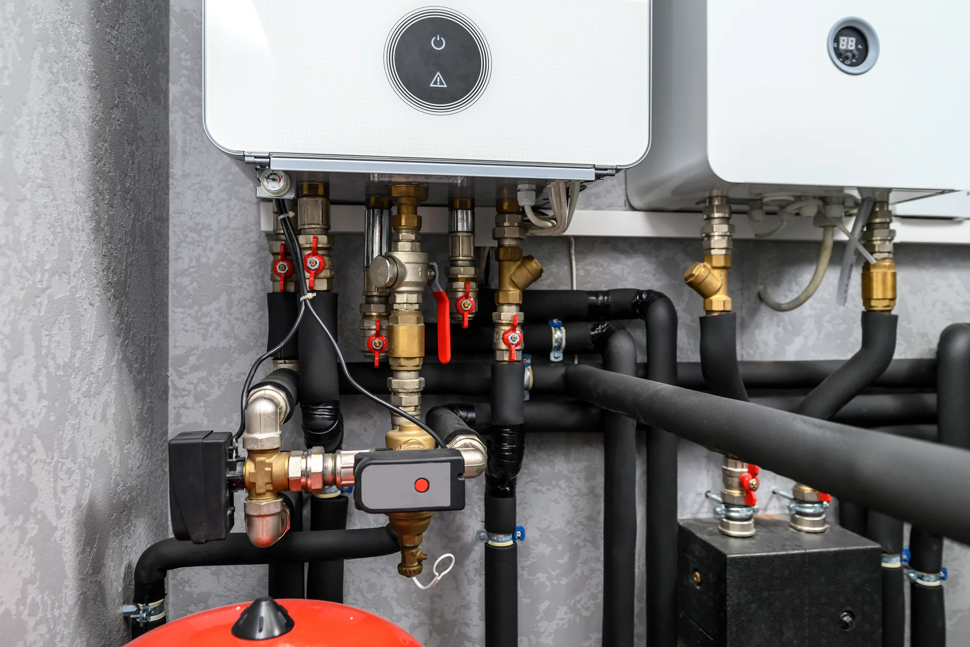 A modern gas boiler system features visible pipes and valves, suitable for HVAC services in Essex County, NJ.