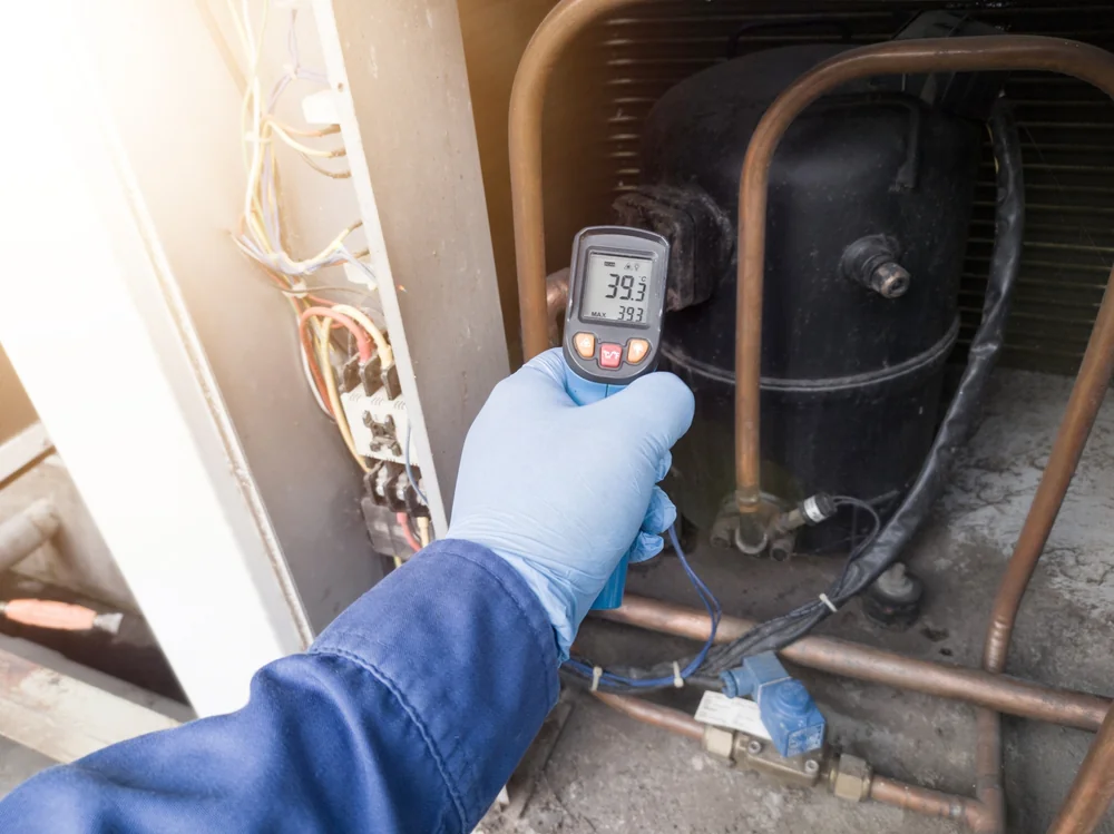 Technician checking temperature during an HVAC service visit in Essex County, New Jersey